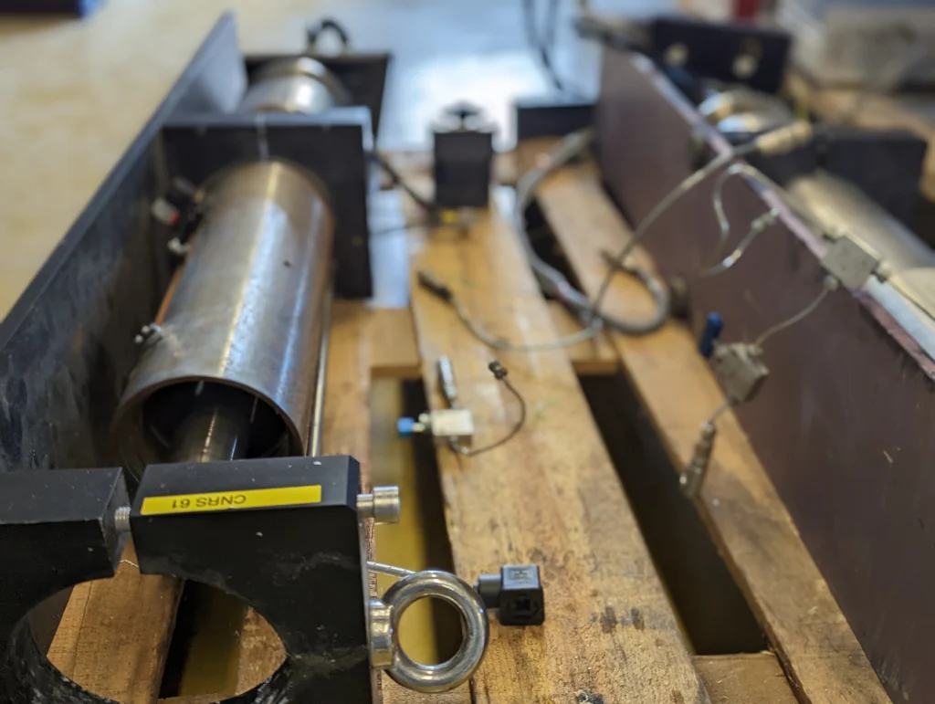 Cylindrical high-pressure vessel in its clamping frame, during assembly in the workshop
